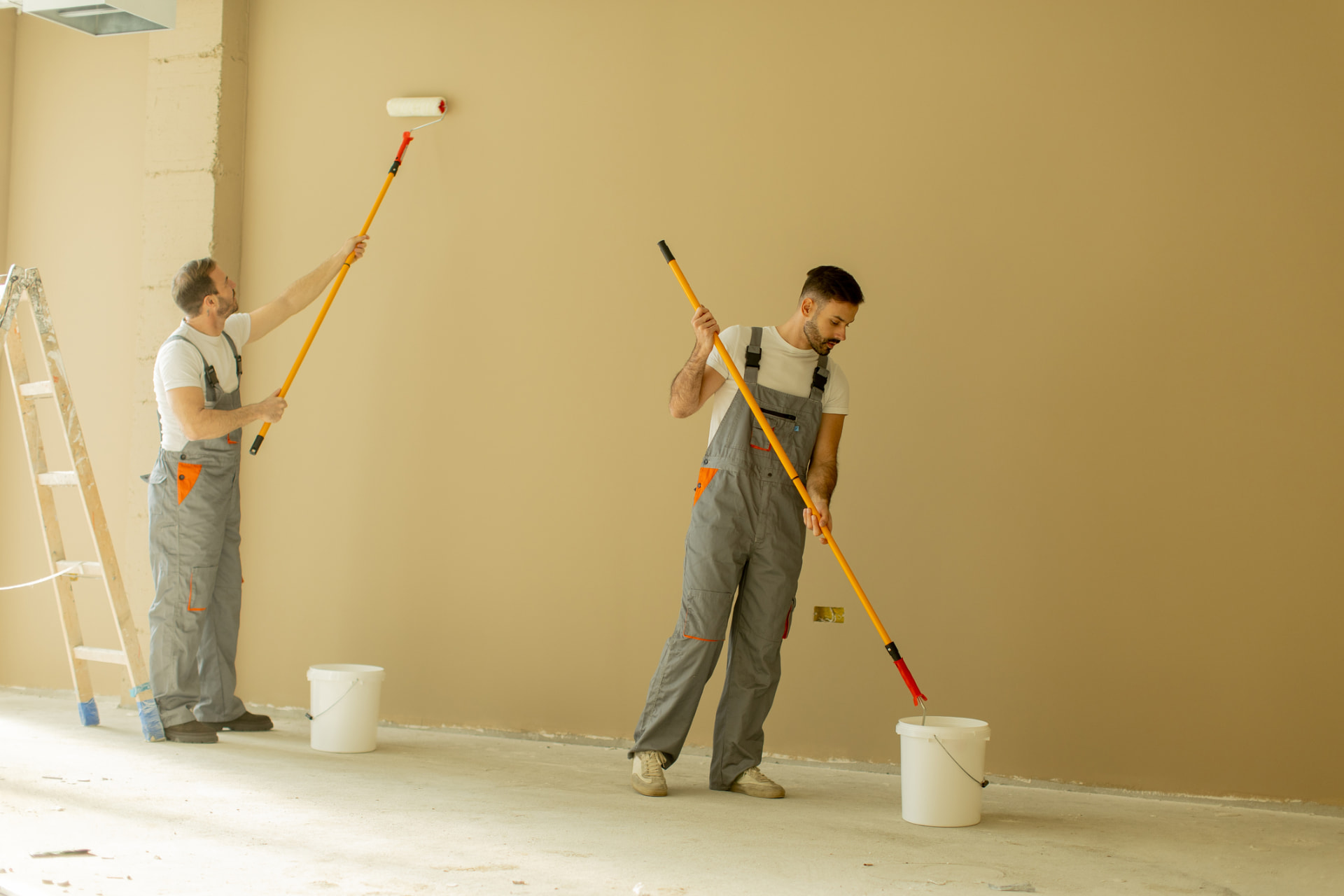 Professional painting crew finishing interior walls in Golden Beach, FL