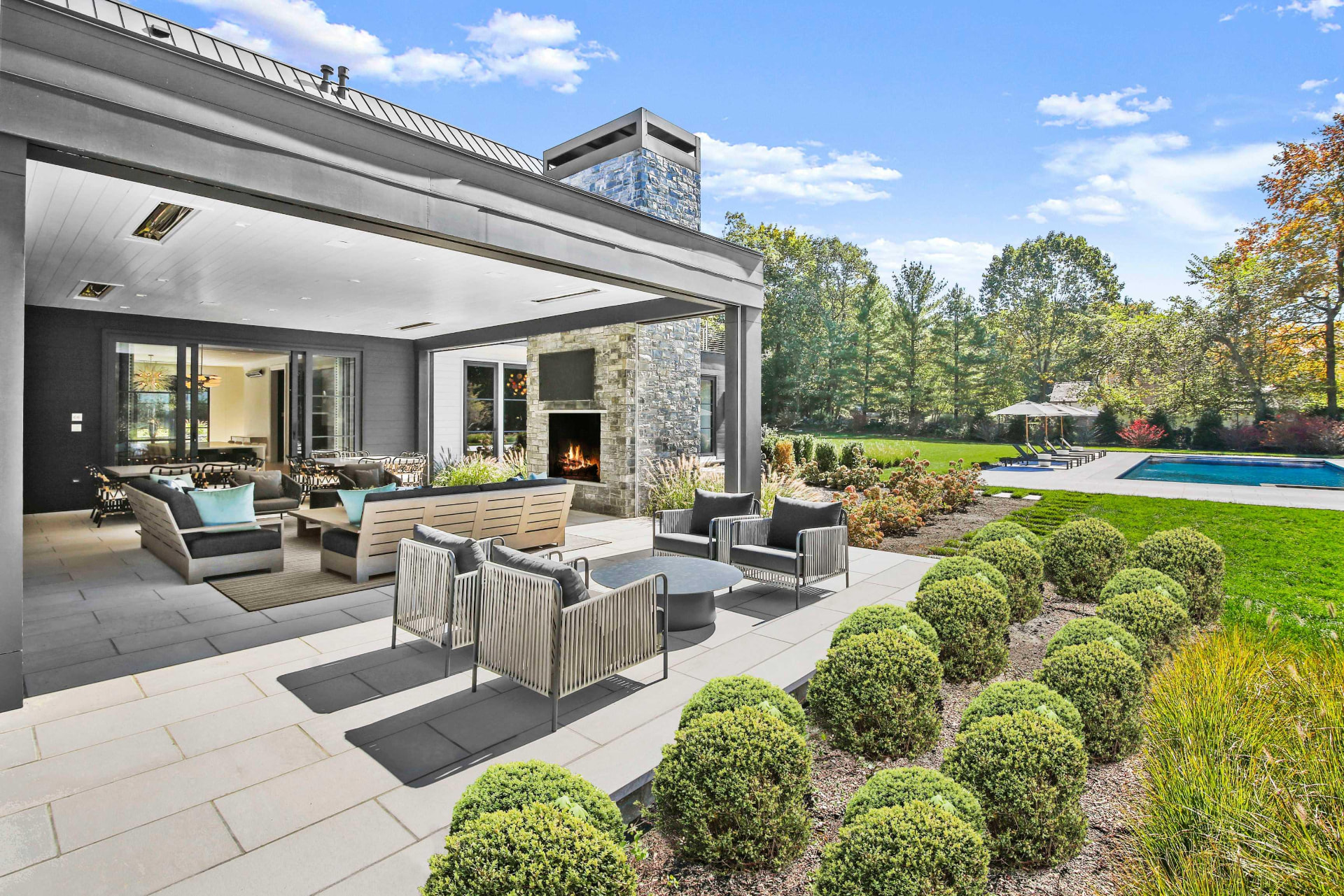 Luxury outdoor living space with covered patio and fireplace