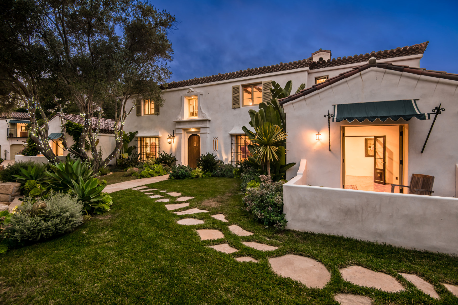 Spanish-style luxury home exterior renovation at dusk in Miami, FL