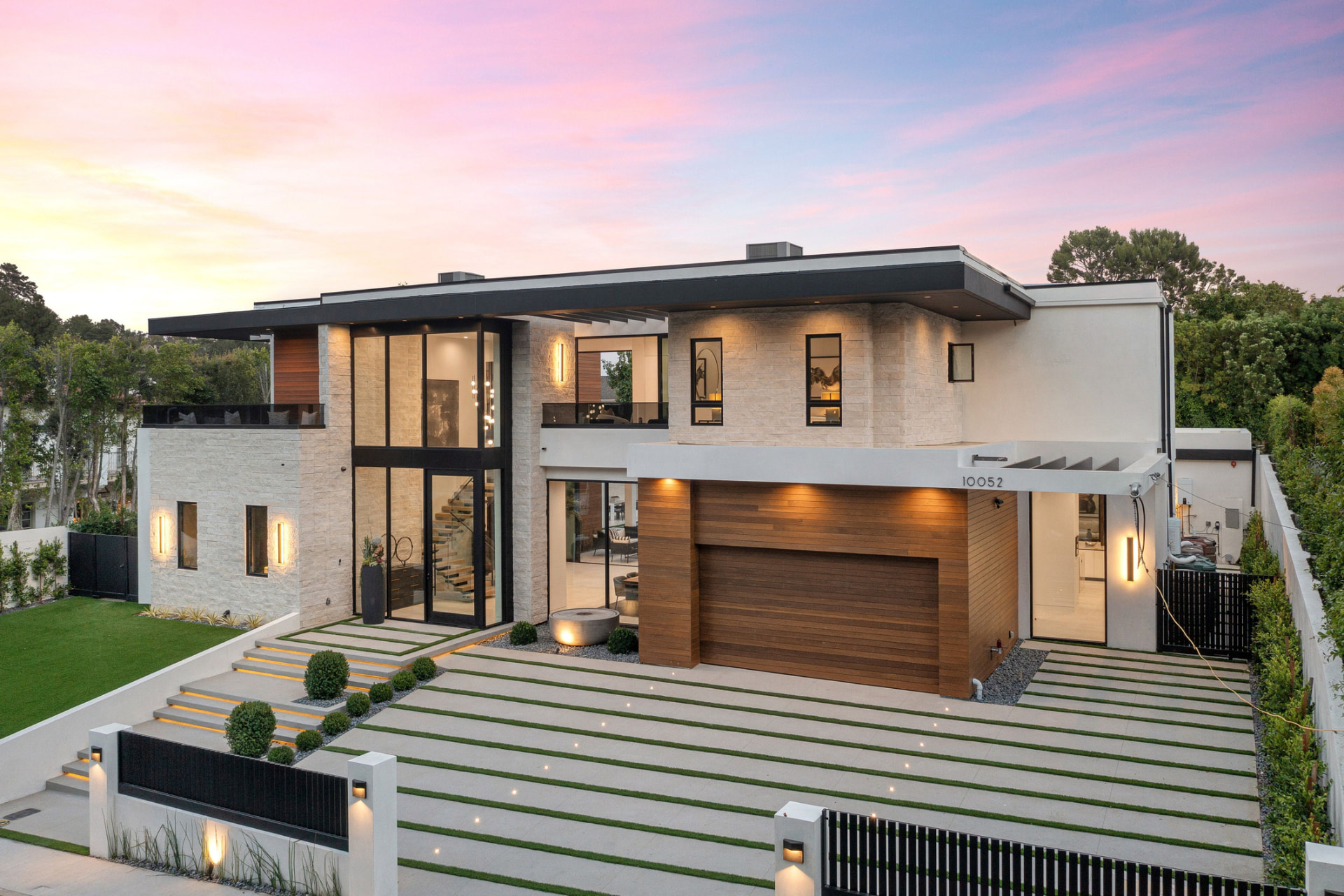 Modern two-story home exterior renovation at dusk in Edgewater, Miami, FL