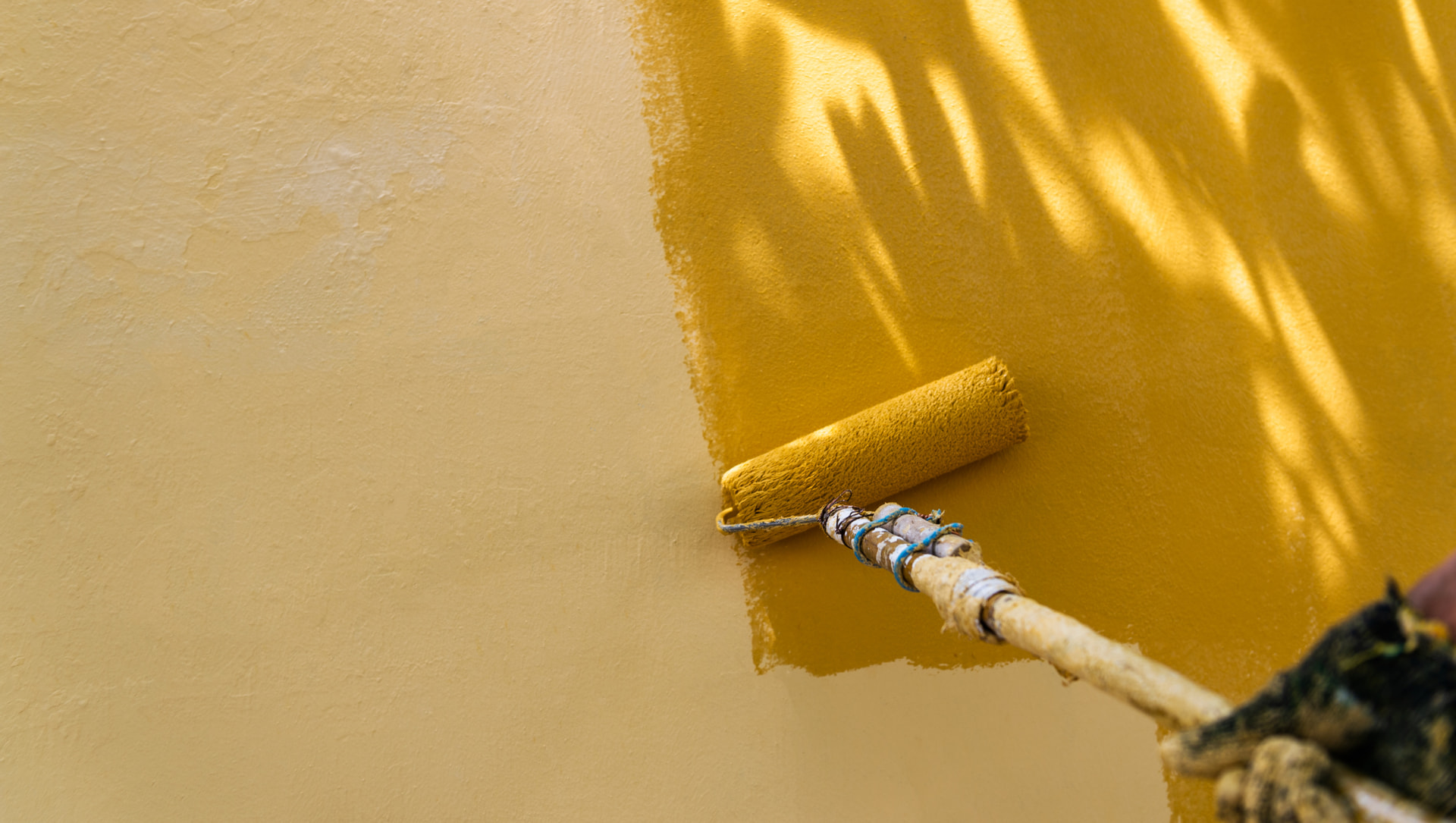 Fresh exterior stucco paint being rolled in Fort Lauderdale, FL