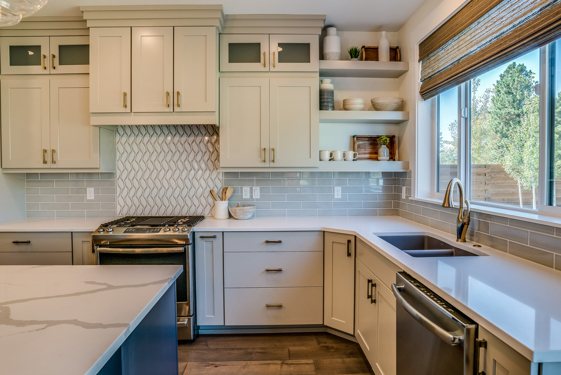 Transitional kitchen with tile backsplash and floating shelves in Coral Gables, FL