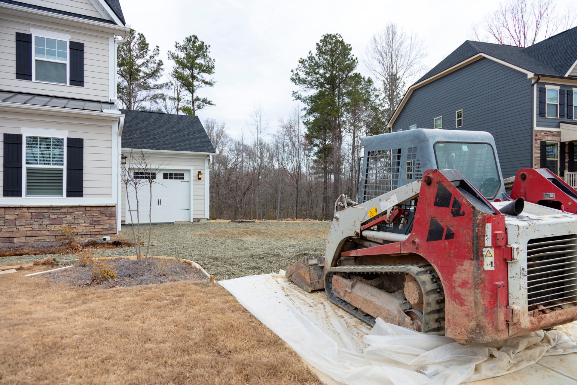 Driveway and yard grading with skid steer during a home renovation in Surfside, FL