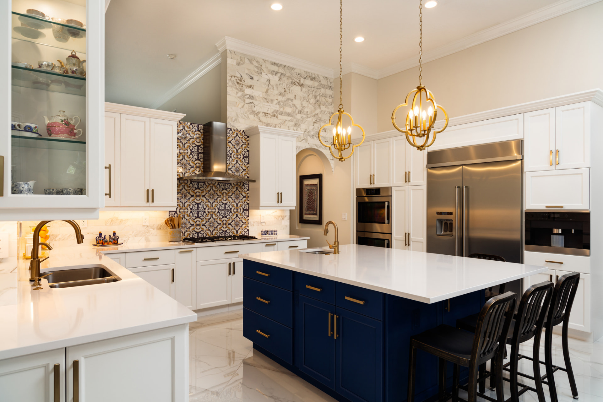 White kitchen remodel with navy island and gold fixtures in Hallandale Beach, FL