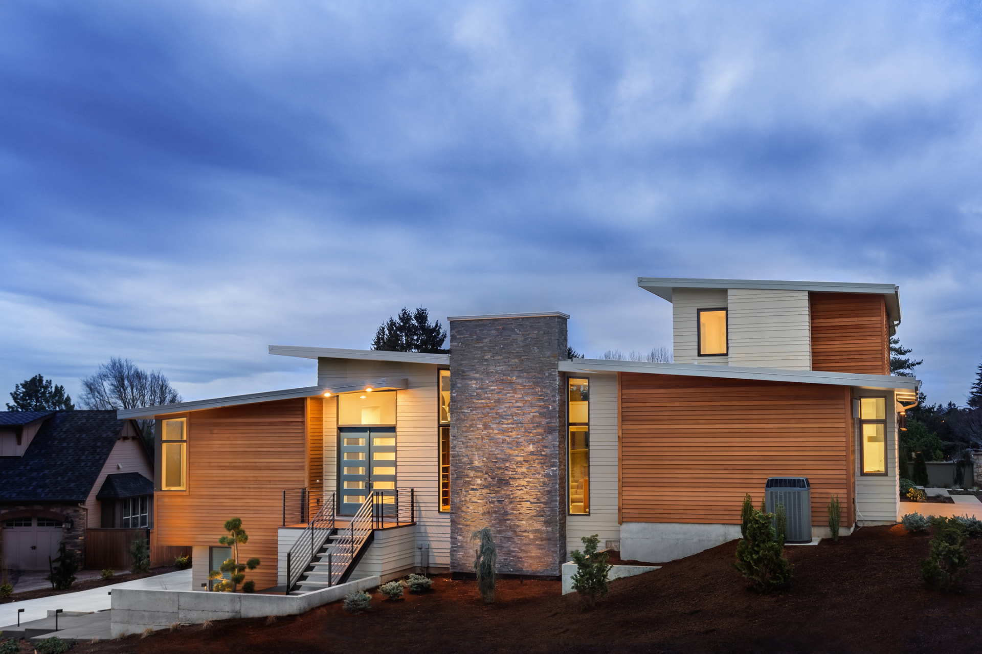 Modern home exterior renovation at dusk in Hallandale Beach, FL