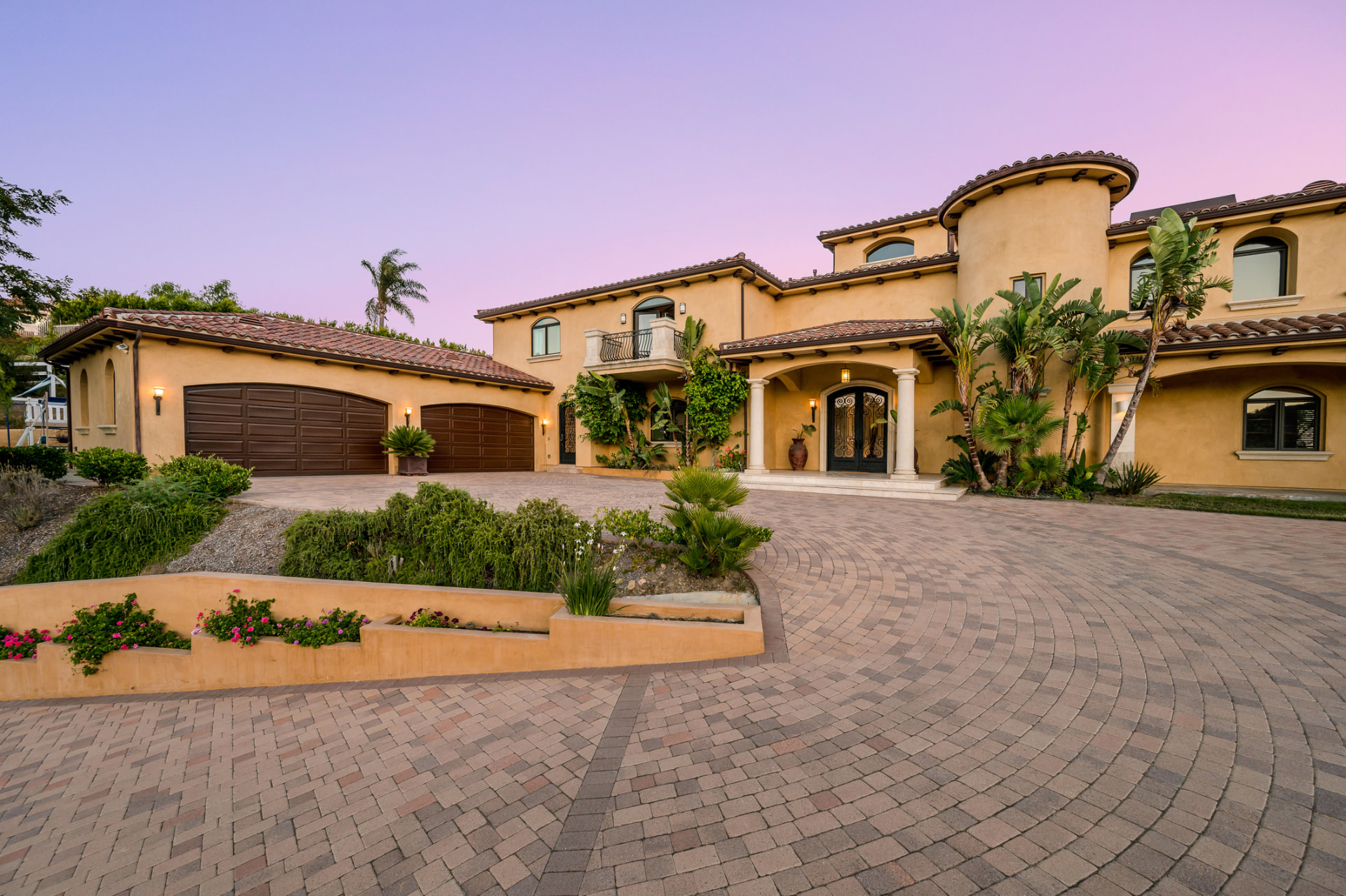 Mediterranean home exterior with paver driveway in Jupiter, FL