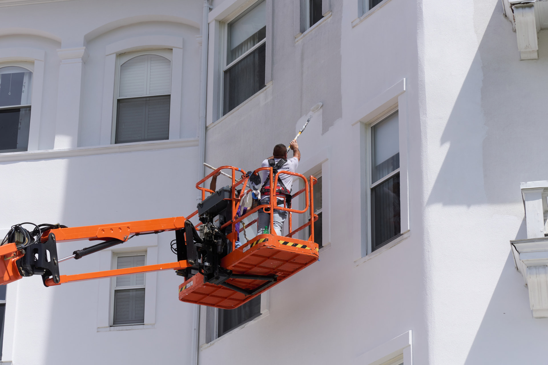 Exterior building repainting from a lift in Fort Lauderdale, FL