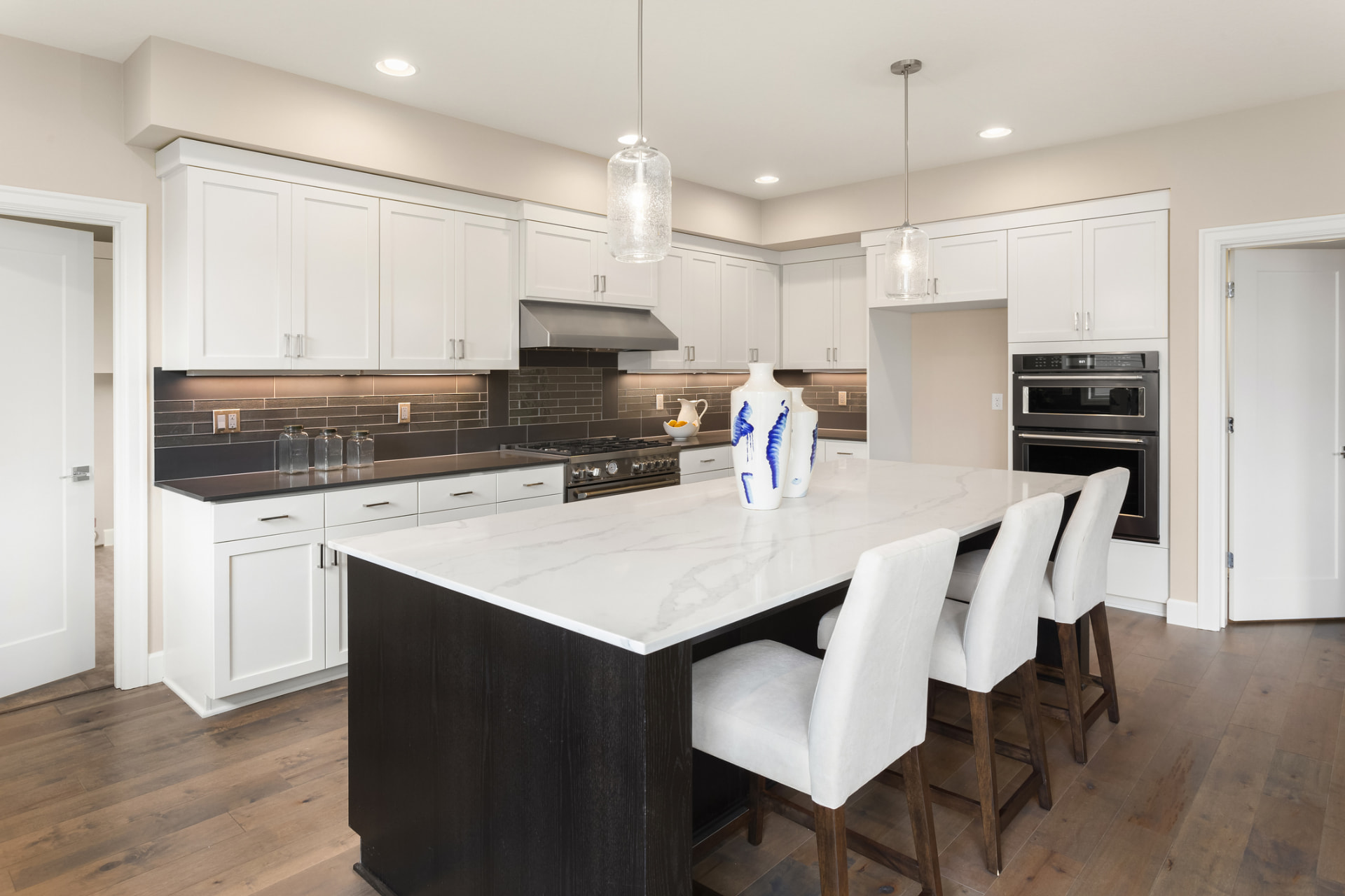 White shaker kitchen with quartz island in Coral Gables, FL