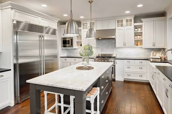Homeowners reviewing kitchen renovation plans and material samples