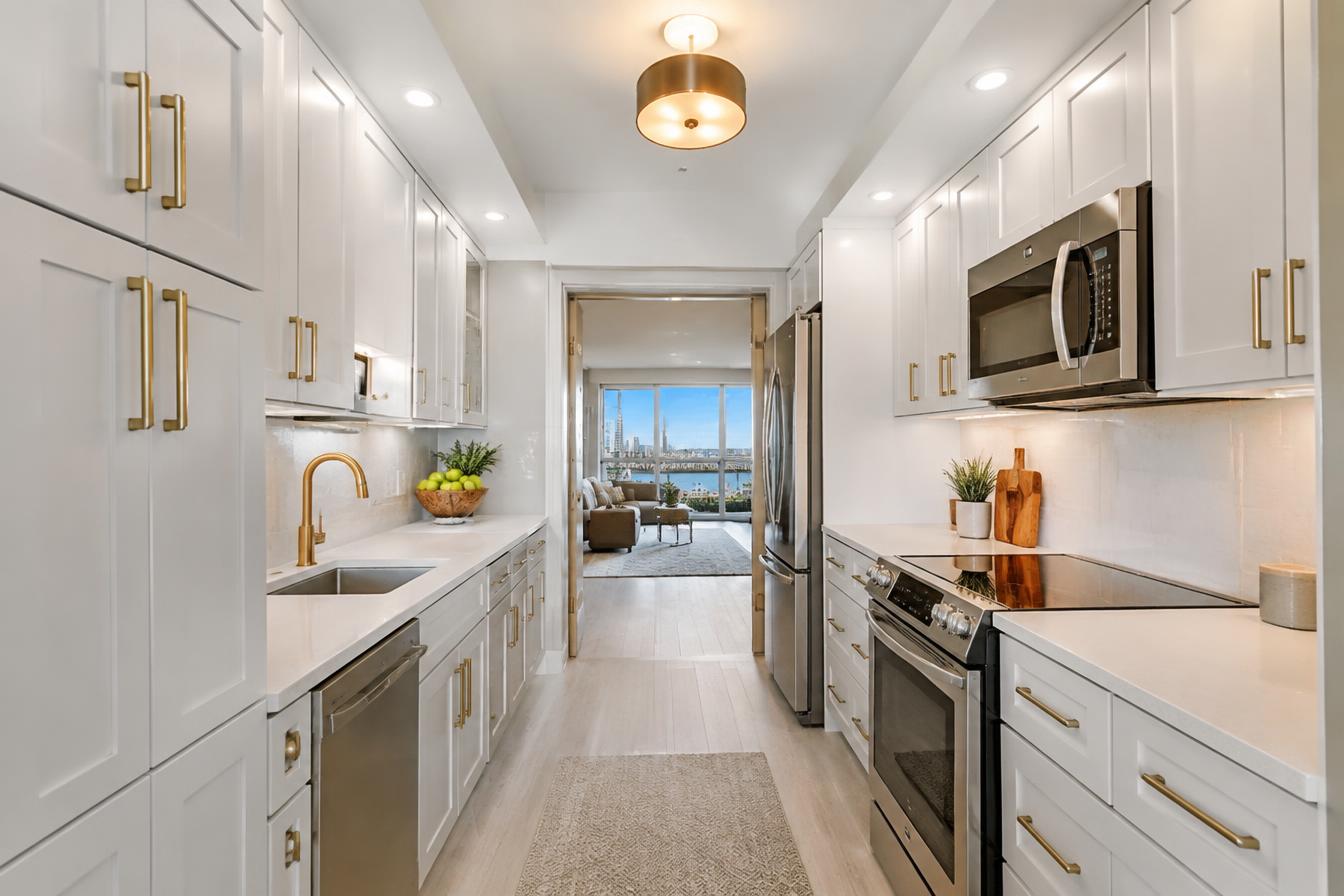 Galley kitchen with two parallel counter runs and ceiling-height cabinetry